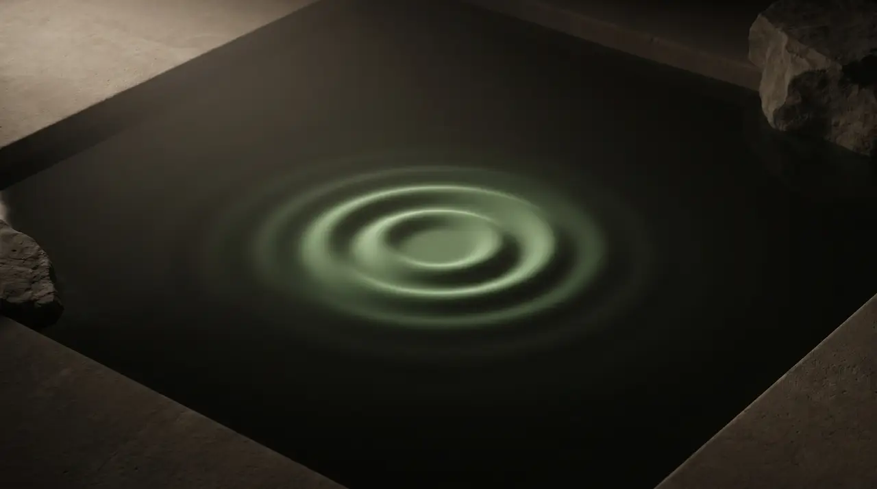 one green ripple expanding across dark still water